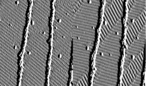 Transition between two competing structures in the epitaxial Ag layer on W(110)